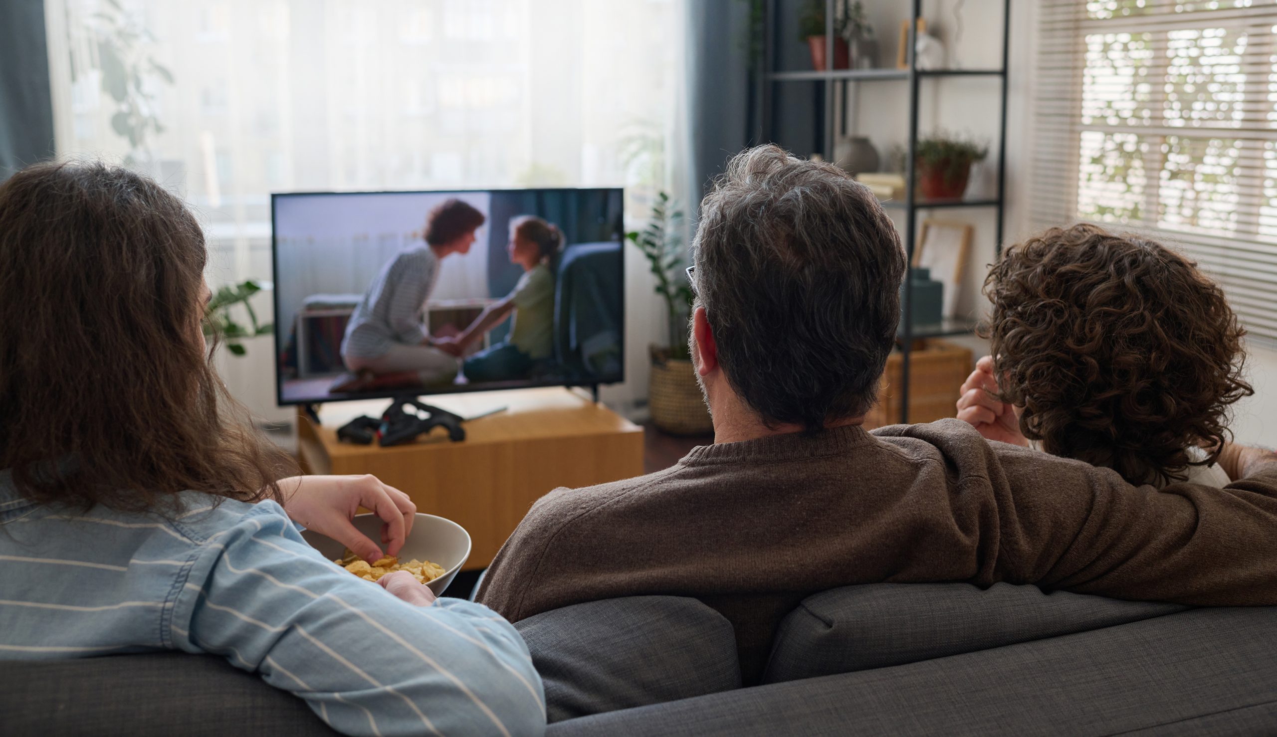 Family watching TV together in the living room